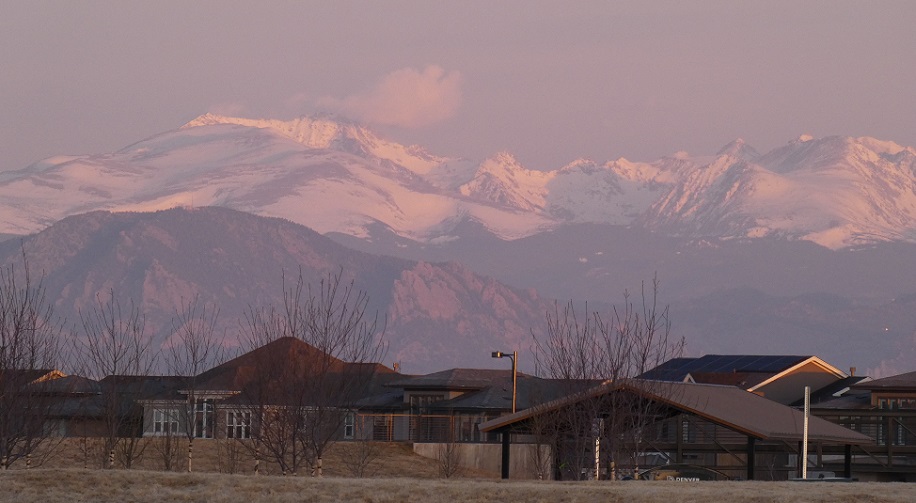 Morning light on the Rocky Mountains seen over Denver, CO